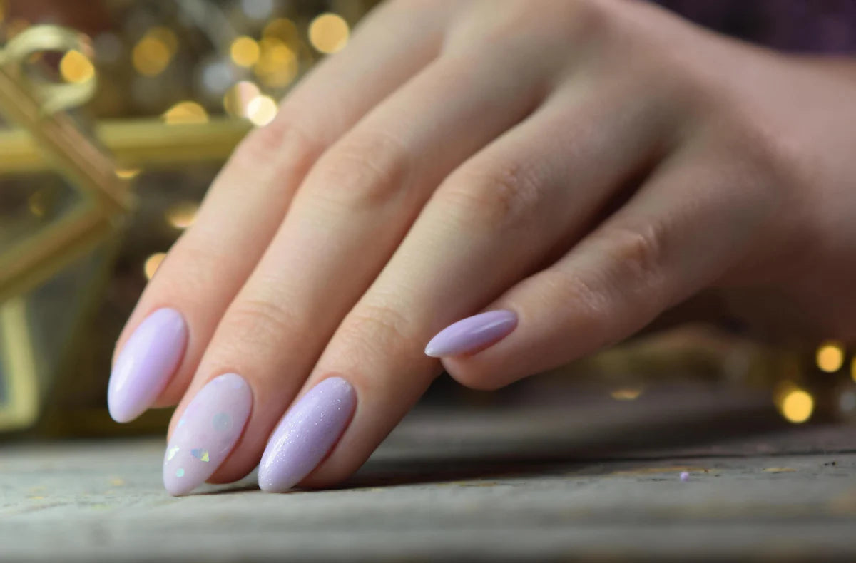 Elegant hand with pastel purple nails showcasing "Inspire" Multi-Flex Gel from Luminary's collection at Alyssita Nail Supply.